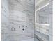 Large shower with marble walls and glass enclosure at 4651 Gulf Of Mexico Dr # 402, Longboat Key, FL 34228
