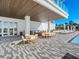 Outdoor patio with seating and bar near the pool at 4651 Gulf Of Mexico Dr # 402, Longboat Key, FL 34228