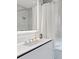Bathroom with a shower, white vanity, and a modern white curtain at 4651 Gulf Of Mexico Dr # 402, Longboat Key, FL 34228
