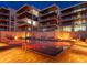 Evening view of resort-style pool with building lights reflecting in the water at 4651 Gulf Of Mexico Dr # 402, Longboat Key, FL 34228