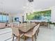 Elegant dining room with large artwork and seating for ten at 4651 Gulf Of Mexico Dr # 402, Longboat Key, FL 34228