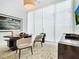 Spacious home office with large windows, built-in shelving, and comfortable seating at 4651 Gulf Of Mexico Dr # 402, Longboat Key, FL 34228