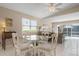 Bright dining area with glass-top table and view of pool at 5793 Ithaca Way, Sarasota, FL 34238