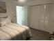 Bedroom featuring neutral bedding, an open door, and a large closet at 6006 Hibiscus Dr # 6006, Bradenton, FL 34207