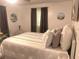 Relaxing bedroom with warm neutral tones, decorated with paintings and comfy pillows at 6006 Hibiscus Dr # 6006, Bradenton, FL 34207