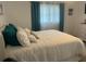 Inviting bedroom featuring a comfortable bed with multiple pillows and plenty of natural light at 6006 Hibiscus Dr # 6006, Bradenton, FL 34207