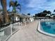 Community pool with lounge chairs and patio tables for relaxation and entertaining on a sunny day at 6006 Hibiscus Dr # 6006, Bradenton, FL 34207