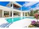 Inviting pool area with expansive patio and two-story home at 680 Longview Dr, Longboat Key, FL 34228