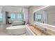 Spa-like bathroom with a soaking tub and modern sink at 800 N Tamiami Trl # 1603, Sarasota, FL 34236