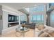 Elegant living room with large windows, fireplace and city views at 800 N Tamiami Trl # 1603, Sarasota, FL 34236
