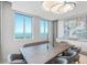 Elegant dining area with water views and a live edge table at 800 N Tamiami Trl # 1603, Sarasota, FL 34236