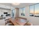 Modern dining area with a large wooden table and water views at 800 N Tamiami Trl # 1603, Sarasota, FL 34236