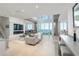 Modern living room boasts a fireplace, large windows, and city views at 800 N Tamiami Trl # 1603, Sarasota, FL 34236