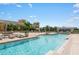 Community pool and jacuzzi with surrounding patio furniture at 800 N Tamiami Trl # 1603, Sarasota, FL 34236