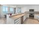 Modern kitchen with stainless steel appliances and an eat in island at 800 N Tamiami Trl # 1603, Sarasota, FL 34236