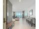Bright entryway with concrete wall and wood bench, leading to spacious living area with water views at 800 N Tamiami Trl # 1603, Sarasota, FL 34236