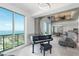 Spacious living room with piano, city view, and modern furniture at 800 N Tamiami Trl # 1603, Sarasota, FL 34236