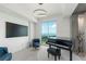 Bright music room with piano, city view, and modern decor at 800 N Tamiami Trl # 1603, Sarasota, FL 34236