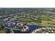 Aerial view of community showcasing its location near a golf course and lake at 9320 Clubside Cir # 2109, Sarasota, FL 34238