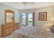 Bedroom with balcony access overlooking a peaceful water view at 9320 Clubside Cir # 2109, Sarasota, FL 34238