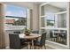 Elegant dining room with a round table, four chairs, and a large mirror at 9869 Haze Dr, Venice, FL 34292