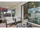 Relaxing screened patio with comfortable seating and view of backyard at 9869 Haze Dr, Venice, FL 34292