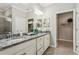 Elegant bathroom with double vanity, granite countertop, and large walk-in shower at 9869 Haze Dr, Venice, FL 34292