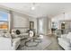Spacious living room with comfortable seating, large windows, and a ceiling fan at 9869 Haze Dr, Venice, FL 34292