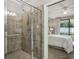 Walk-in shower with glass enclosure and neutral tile at 9869 Haze Dr, Venice, FL 34292