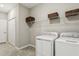 Laundry room with washer, dryer, and additional shelving at 9869 Haze Dr, Venice, FL 34292