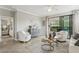 Bright living room with comfortable seating, access to a patio, and natural light at 9869 Haze Dr, Venice, FL 34292