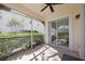 Screened porch with ceiling fan and view of lush landscaping at 4260 Central Sarasota Pkwy # 213, Sarasota, FL 34238