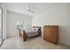Bedroom with wood dresser and double bed, access to a patio at 4260 Central Sarasota Pkwy # 213, Sarasota, FL 34238
