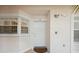 Condo building entry with white door and window shutters at 4260 Central Sarasota Pkwy # 213, Sarasota, FL 34238