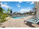 Community pool with lounge chairs and surrounding landscaping at 4260 Central Sarasota Pkwy # 213, Sarasota, FL 34238