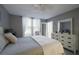 Spacious bedroom with king bed, dresser, and window with sheer curtains at 4550 Pinebrook Cir # 103, Bradenton, FL 34209