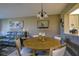 Bright dining area with round table, four chairs, and view into kitchen at 4550 Pinebrook Cir # 103, Bradenton, FL 34209