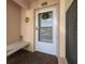 Condo front door entrance with a small bench and tiled flooring at 4550 Pinebrook Cir # 103, Bradenton, FL 34209