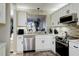 Modern kitchen with white cabinets, stainless steel appliances, and stone backsplash at 4550 Pinebrook Cir # 103, Bradenton, FL 34209