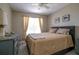 Bedroom with king-size bed, dresser, and window with blinds at 4550 Pinebrook Cir # 103, Bradenton, FL 34209
