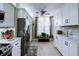 Modern kitchen with white cabinets, stainless steel appliances, and stone backsplash at 4550 Pinebrook Cir # 103, Bradenton, FL 34209