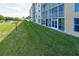 Condo building with grassy lawn and lake view at 4550 Pinebrook Cir # 103, Bradenton, FL 34209