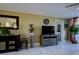 Living room featuring a large TV, comfortable furniture, and marble flooring at 4550 Pinebrook Cir # 103, Bradenton, FL 34209