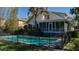 White house with screened porch and fenced-in pool at 908 Pomelo Ave, Sarasota, FL 34236