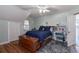 Cozy bedroom featuring a wooden storage trunk and a dark blue comforter at 908 Pomelo Ave, Sarasota, FL 34236