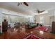 Spacious living room with hardwood floors, two ceiling fans, and ample natural light at 908 Pomelo Ave, Sarasota, FL 34236