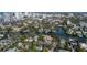 Wide aerial showcasing a neighborhood near the water and a city skyline in the distance at 908 Pomelo Ave, Sarasota, FL 34236