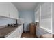 Small kitchen with white cabinets and a light blue color scheme at 908 Pomelo Ave, Sarasota, FL 34236