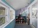 Bright sunroom with light blue walls and storage shelving at 908 Pomelo Ave, Sarasota, FL 34236