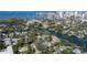 Aerial view of waterfront property showing canal, boats, and nearby city skyline at 908 Pomelo Ave, Sarasota, FL 34236
